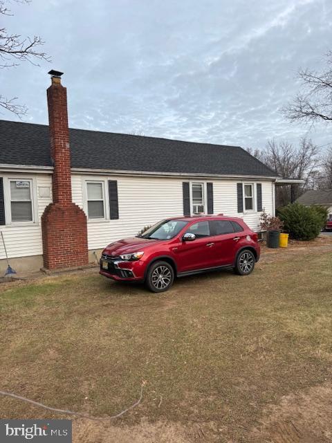 view of side of home with a lawn