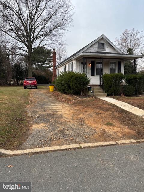 11 Heath St, Trenton, NJ 08638 - view of front of property with dirt driveway, covered porch, and a chimney
