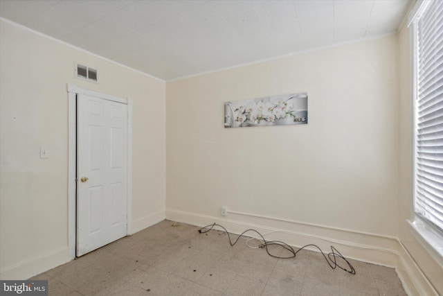 unfurnished room with ornamental molding