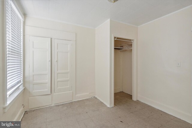 2048 S Croskey St, Philadelphia, PA 19145 - unfurnished bedroom with light floors, baseboards, a closet, and crown molding
