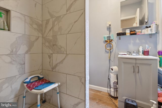 bathroom featuring hardwood / wood-style floors, sink, and tile walls