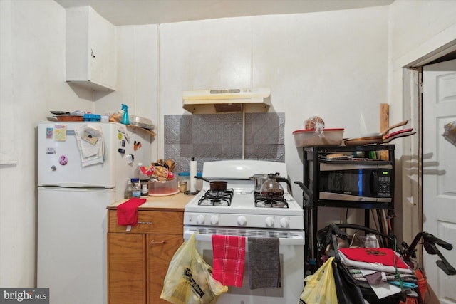 kitchen with white cabinets and white appliances