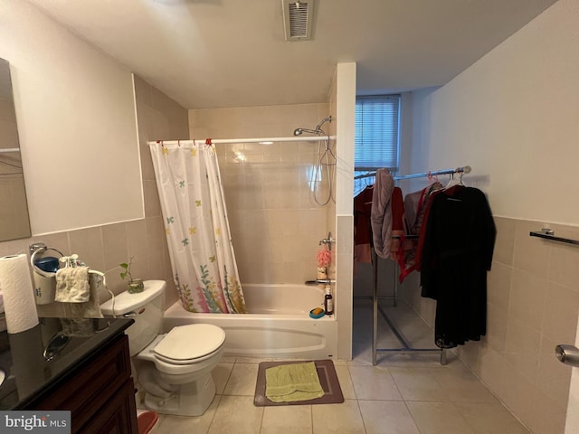 full bathroom featuring vanity, shower / bath combo, tile patterned flooring, toilet, and tile walls