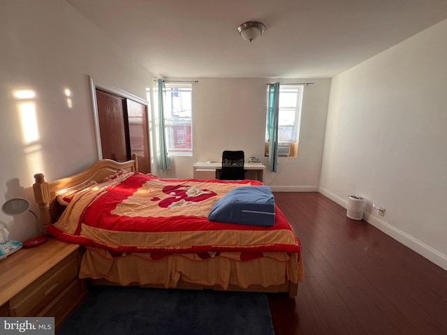 bedroom featuring cooling unit and dark wood-type flooring