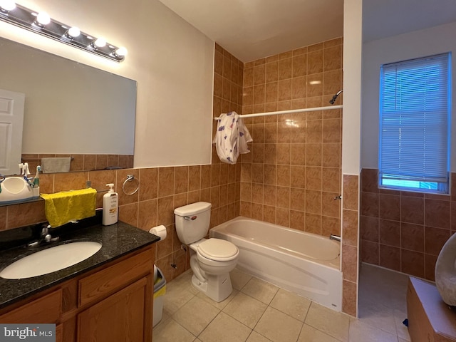 full bathroom featuring tile patterned floors, vanity, toilet, and tile walls