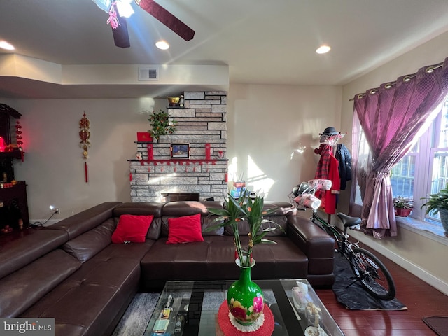 living room with dark hardwood / wood-style flooring and a fireplace