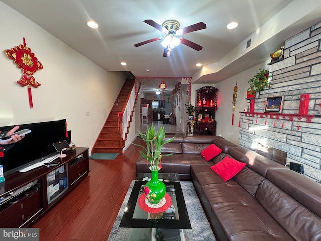 living room with ceiling fan and dark wood-type flooring