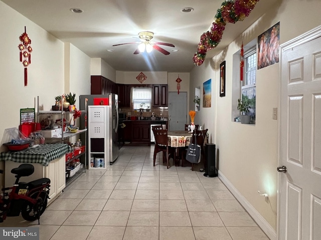 kitchen with dark brown cabinets, ceiling fan, light tile patterned floors, and appliances with stainless steel finishes