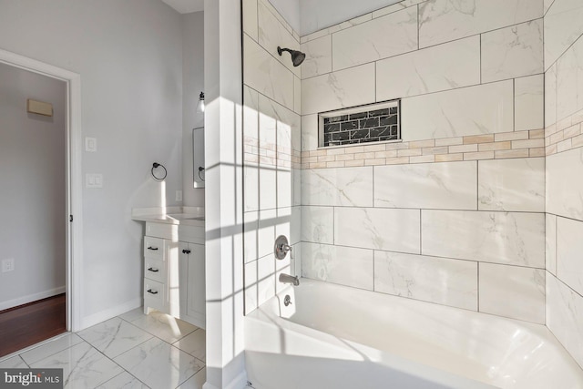 bathroom featuring vanity and tiled shower / bath