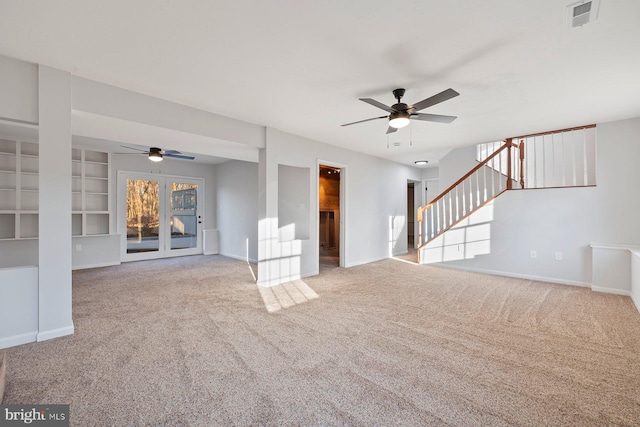 unfurnished living room featuring light colored carpet and ceiling fan