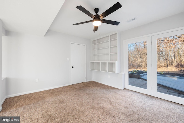 spare room featuring carpet and ceiling fan