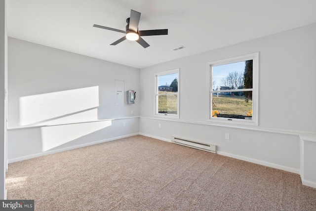 carpeted spare room with ceiling fan and a baseboard radiator