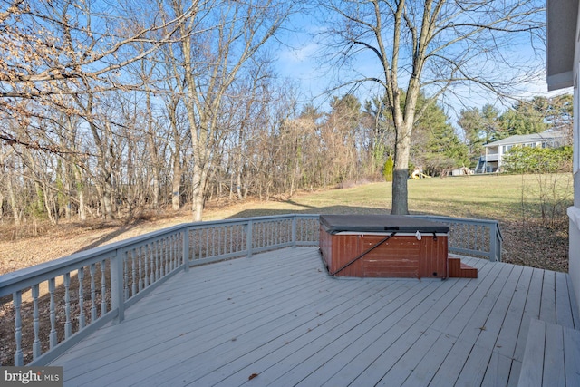 deck featuring a lawn and a hot tub