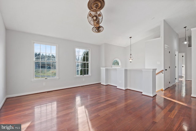 unfurnished living room with lofted ceiling and dark wood-type flooring