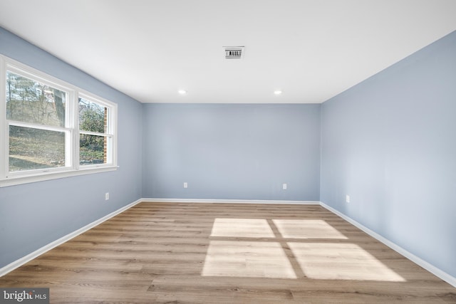 unfurnished room with light wood-type flooring