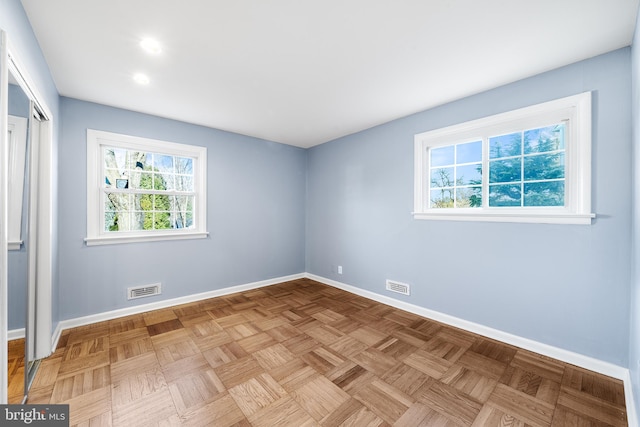 unfurnished room featuring light parquet flooring