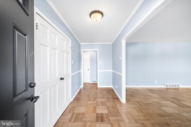 hallway with light parquet flooring and crown molding