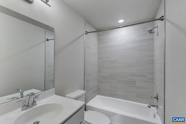 full bathroom with tiled shower / bath combo, toilet, and vanity