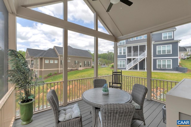 sunroom / solarium with ceiling fan and vaulted ceiling