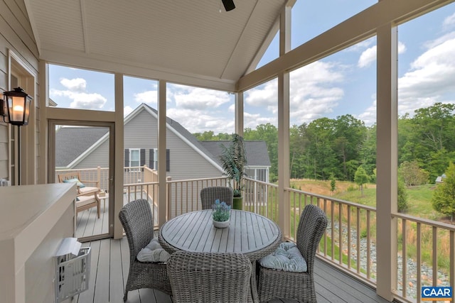 sunroom featuring vaulted ceiling