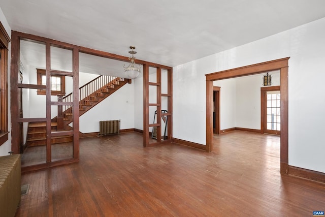 unfurnished room featuring radiator heating unit, french doors, and hardwood / wood-style floors