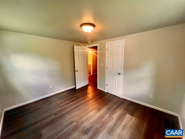 unfurnished bedroom with dark hardwood / wood-style floors