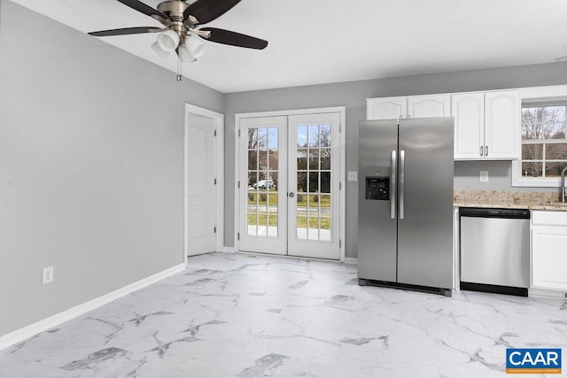 kitchen featuring white cabinets, ceiling fan, stainless steel appliances, and french doors