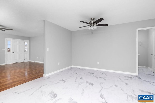 empty room with ceiling fan and wood-type flooring