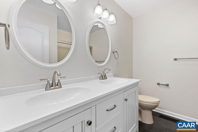 bathroom featuring tile patterned floors, vanity, and toilet