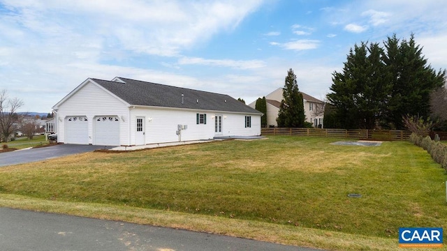 exterior space with a yard and a garage