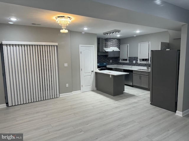 kitchen with gray cabinets, black range with electric stovetop, refrigerator, and light wood-type flooring