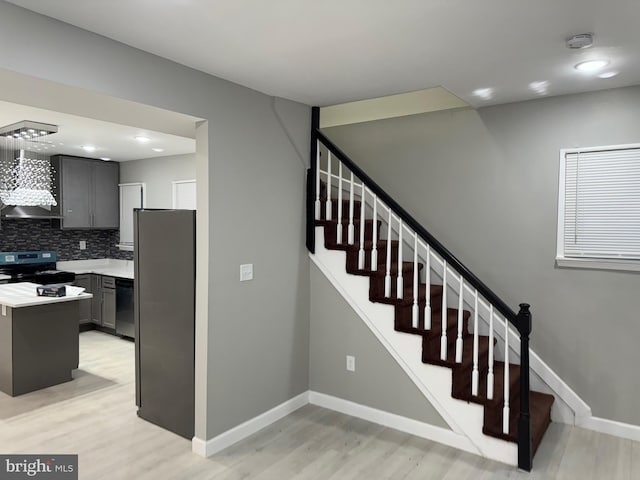 stairs with hardwood / wood-style floors