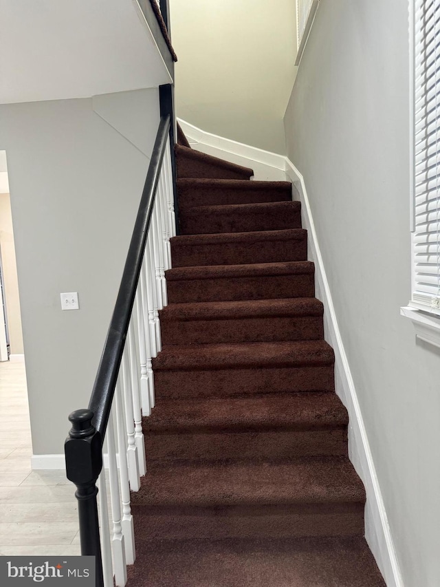 staircase featuring hardwood / wood-style floors