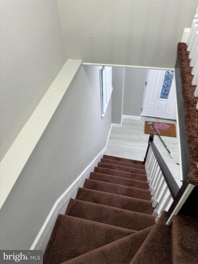 stairs with hardwood / wood-style flooring