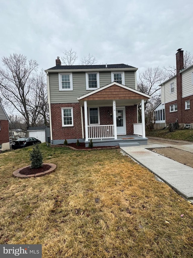 view of front of home with covered porch and a front yard