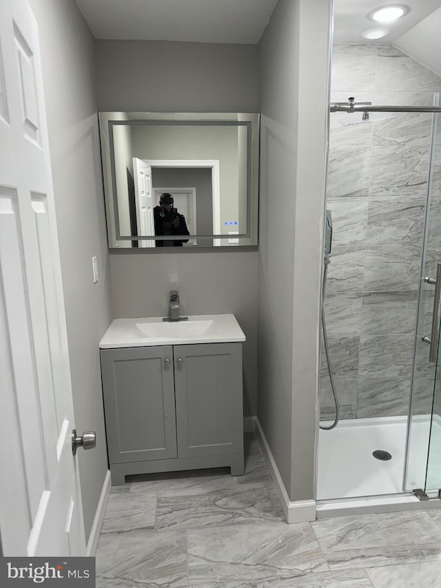 bathroom featuring vaulted ceiling, vanity, and an enclosed shower