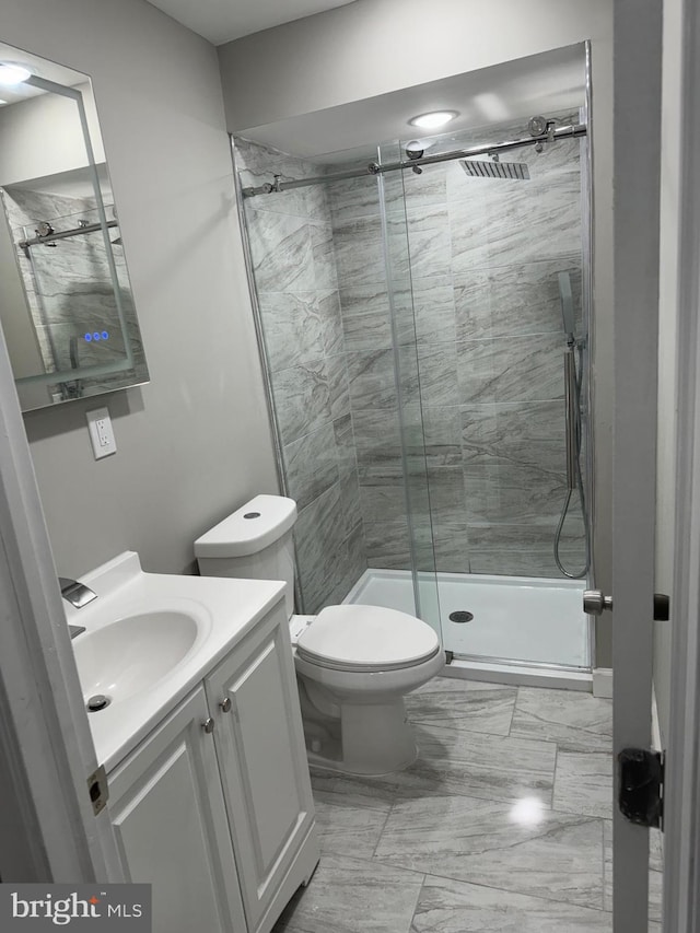 bathroom with vanity, toilet, and an enclosed shower