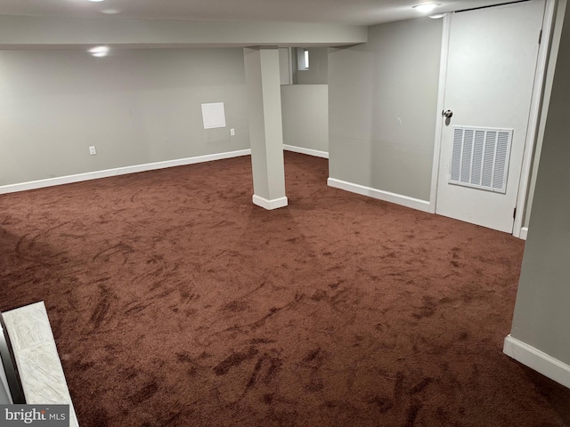 basement featuring dark colored carpet