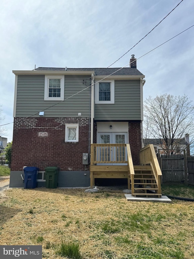 rear view of house featuring a yard and a wooden deck