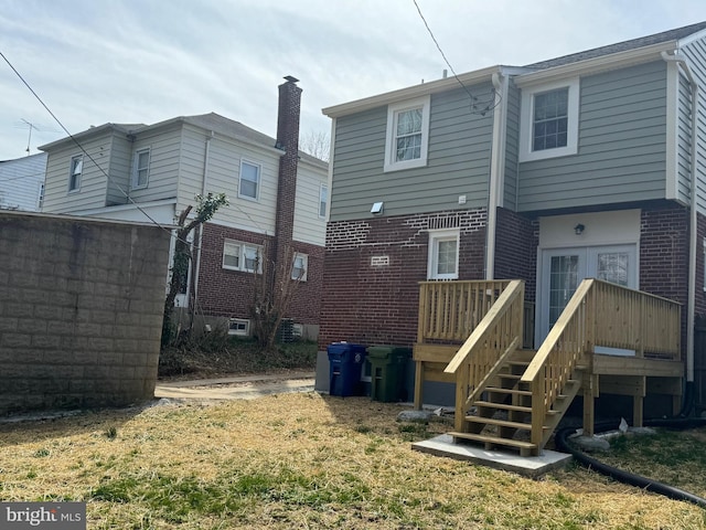 back of house featuring a wooden deck