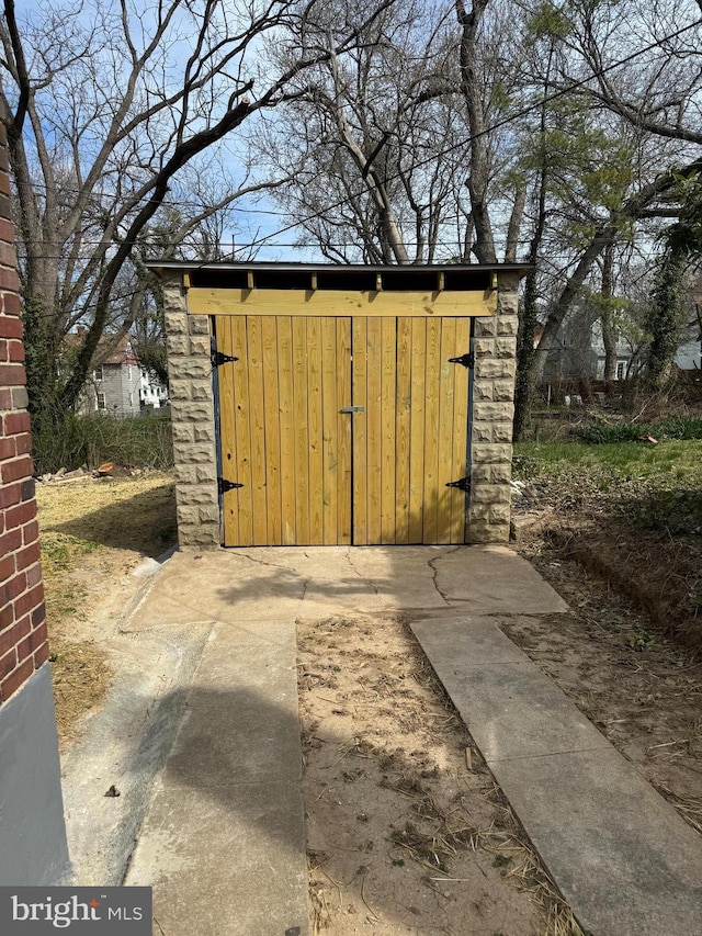 view of gate featuring a storage shed