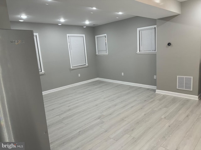 unfurnished room with light hardwood / wood-style flooring