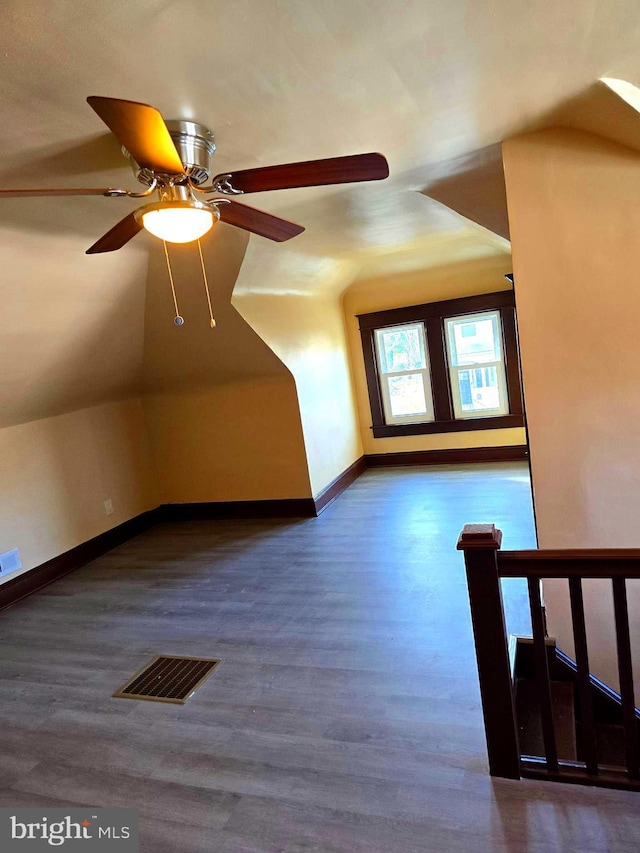 bonus room with vaulted ceiling, ceiling fan, and dark hardwood / wood-style floors