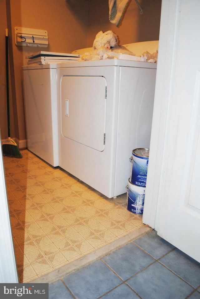 clothes washing area with washer and clothes dryer