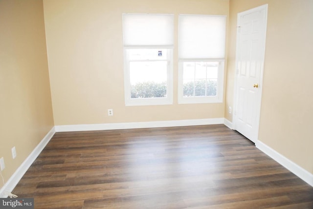 spare room featuring dark hardwood / wood-style floors