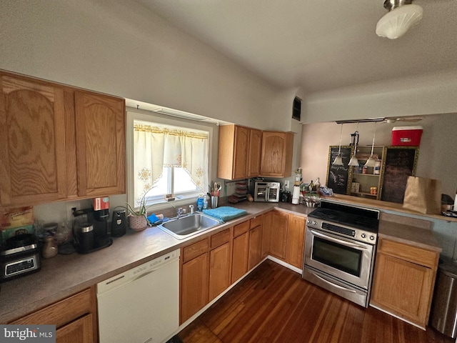 kitchen with dishwasher, dark hardwood / wood-style floors, sink, and high end stainless steel range