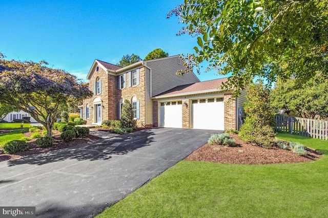 view of front of house featuring a front lawn and a garage