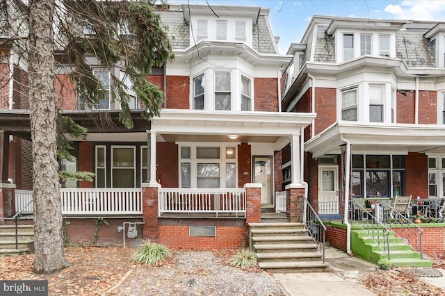 townhome / multi-family property with covered porch