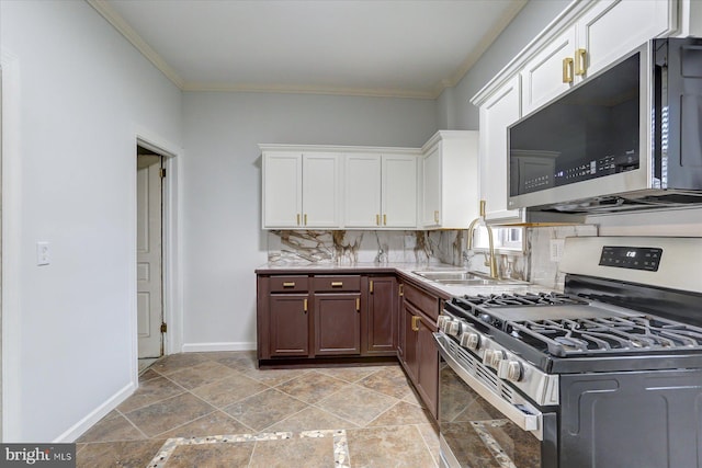 kitchen featuring backsplash, white cabinets, crown molding, sink, and appliances with stainless steel finishes