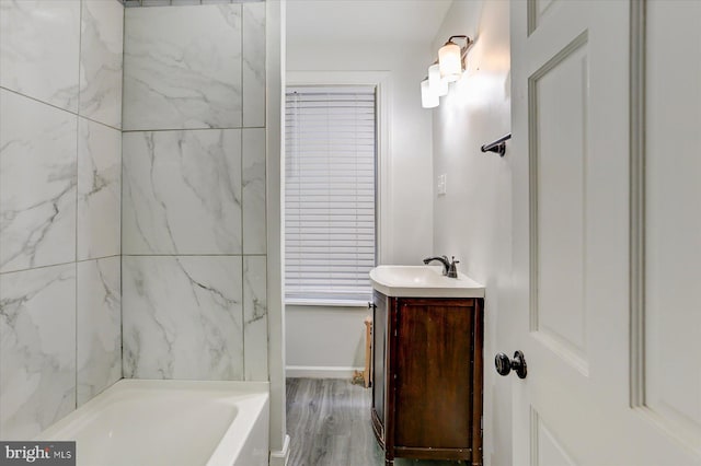 bathroom featuring a bathtub, vanity, and wood-type flooring